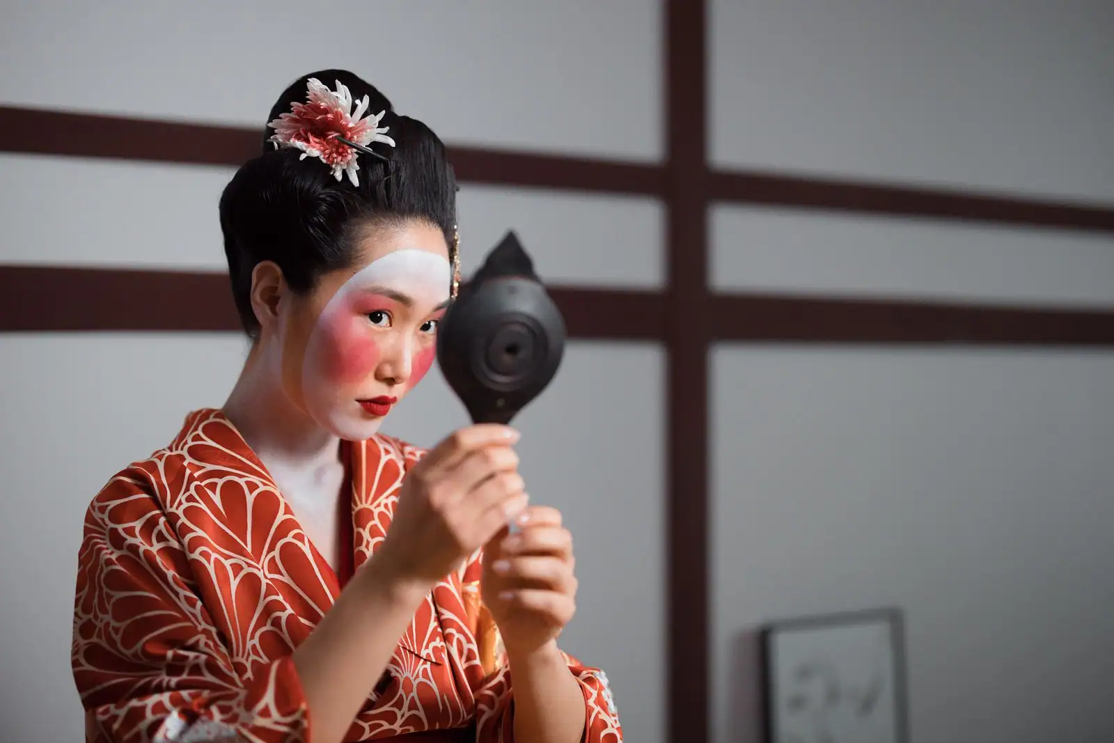 Maquillage traditionnel de geisha au visage blanc et aux lèvres rouges